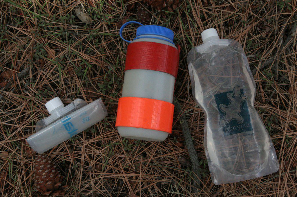 This combination of water bottles works well. The rigid Nalgene in the middle is used for drinking and the Paltypus soft bottle are used to store extra water in the pack.