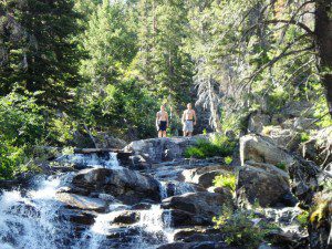Blake Miller's sons pose at a waterfall in the backcountry.