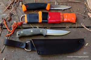 The Mora sheath, top needs to be modified for safe carry. The Feather Stick comes with a leather dangler.