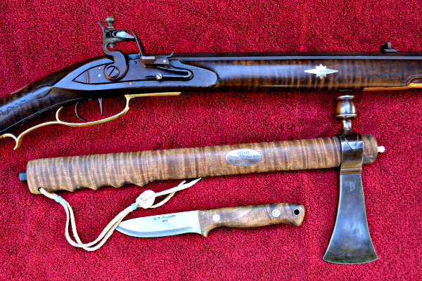 flintlock rifle, tomahawk and knife