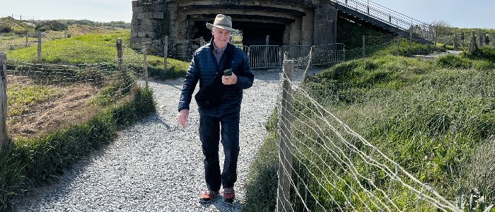 Leon Pantenburg walking on a rock path at Normandy beaches in France