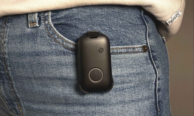 personal alert mobile device clipped to a jeans pocket
