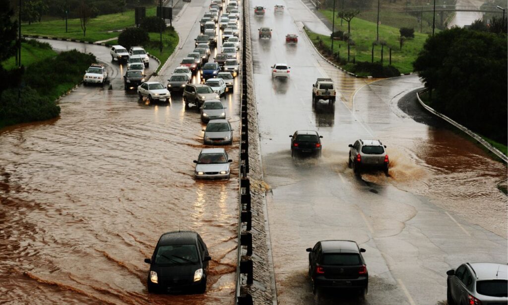 flooded streets and cars trying to drive on it