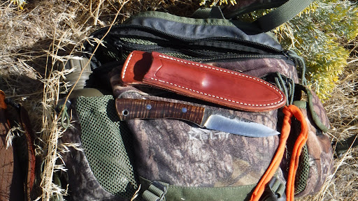 knife and gear on top of a day pack
