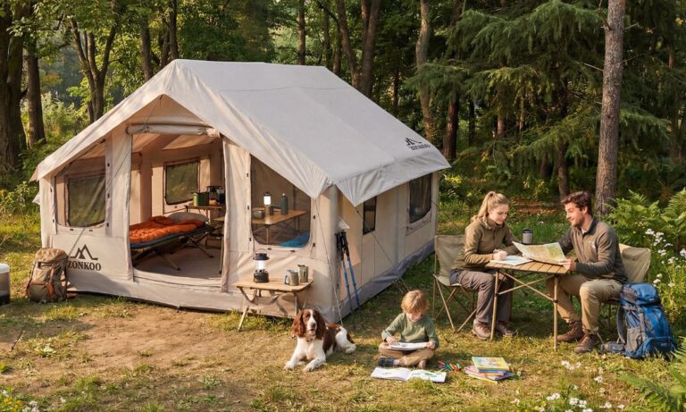 family camping with parents at a table and child on the ground with dog