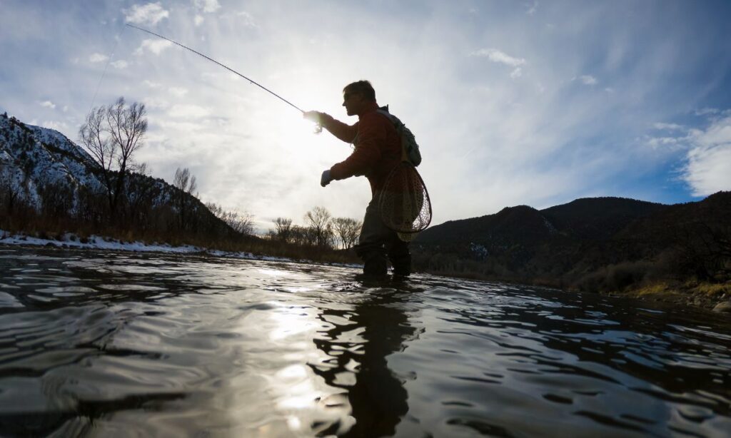 fly fishing in cold water with snow on banks