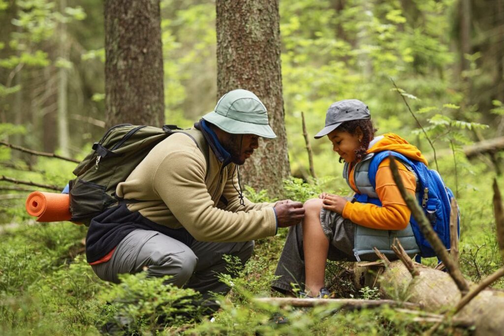 father and daughter in the woods hiking
